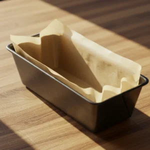 Equip 3 - loaf pan lined with parchment paper for banana bread