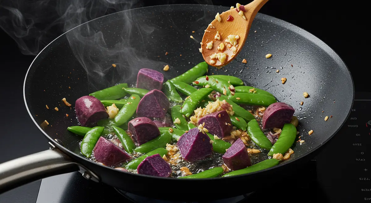 Purple sweet potatoes, snap peas, shallots, and garlic stir-fried in a wok